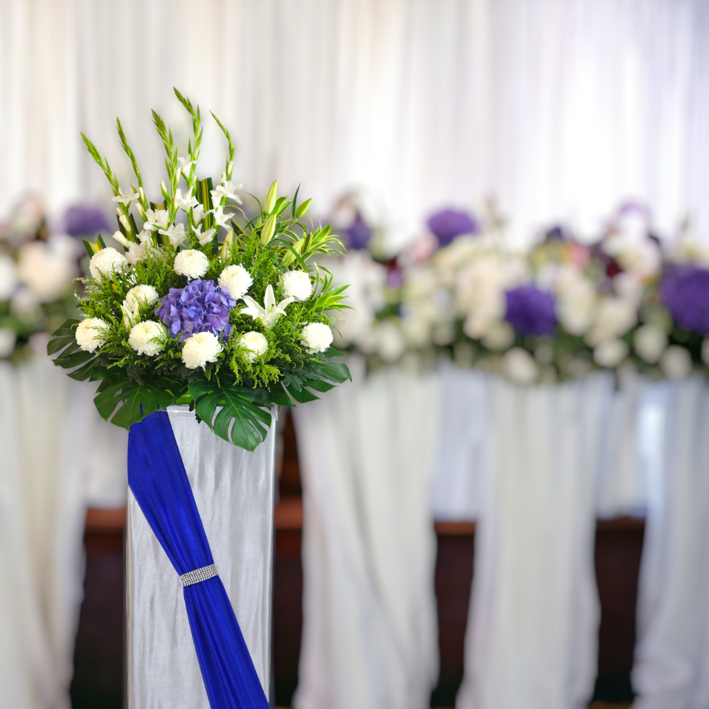 Elegant singapore-style <$200 condolences flower stand at a formal funeral wake