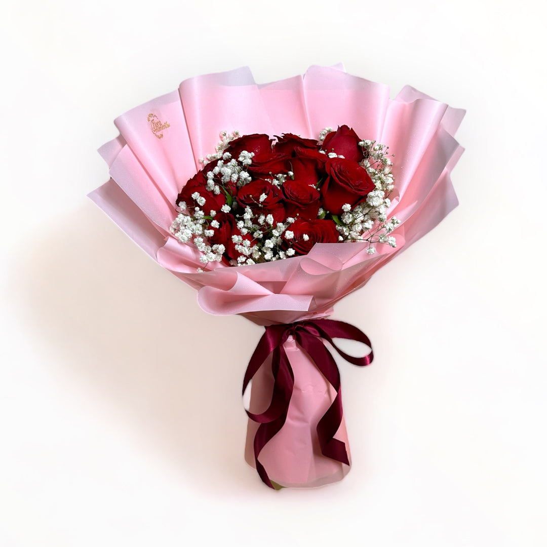 bouquet-of-12-stalks-red-roses-with-babys-breath-wrapped-in-pink-front