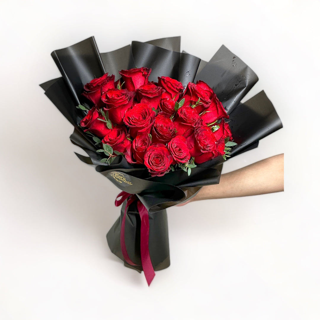bouquet-of-24-stalks-red-roses-wrapped-in-black-hand