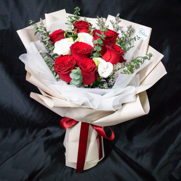 flowerbouquet-redroses-whiteeustoma-eucalyptus-cream-wrapper-with-black-background